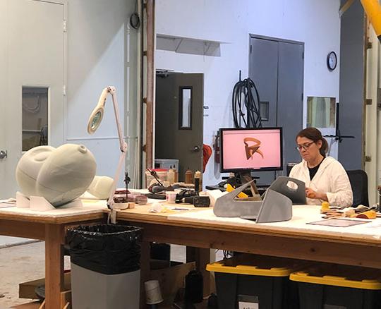 woman sitting at desk with computer