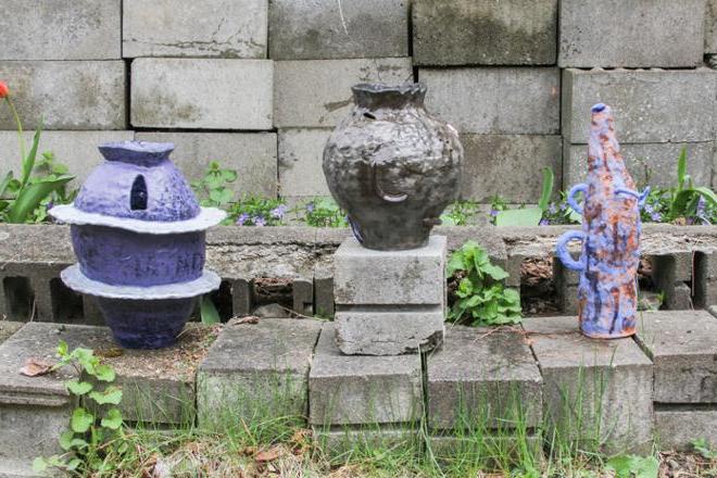 Three ceramic vase forms, pictured outside.     
