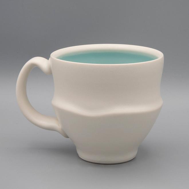 white mug with a textured stripe and a soft blue interior