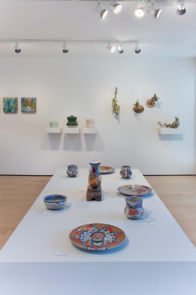 gallery space filled with plates, vases and other items for sale